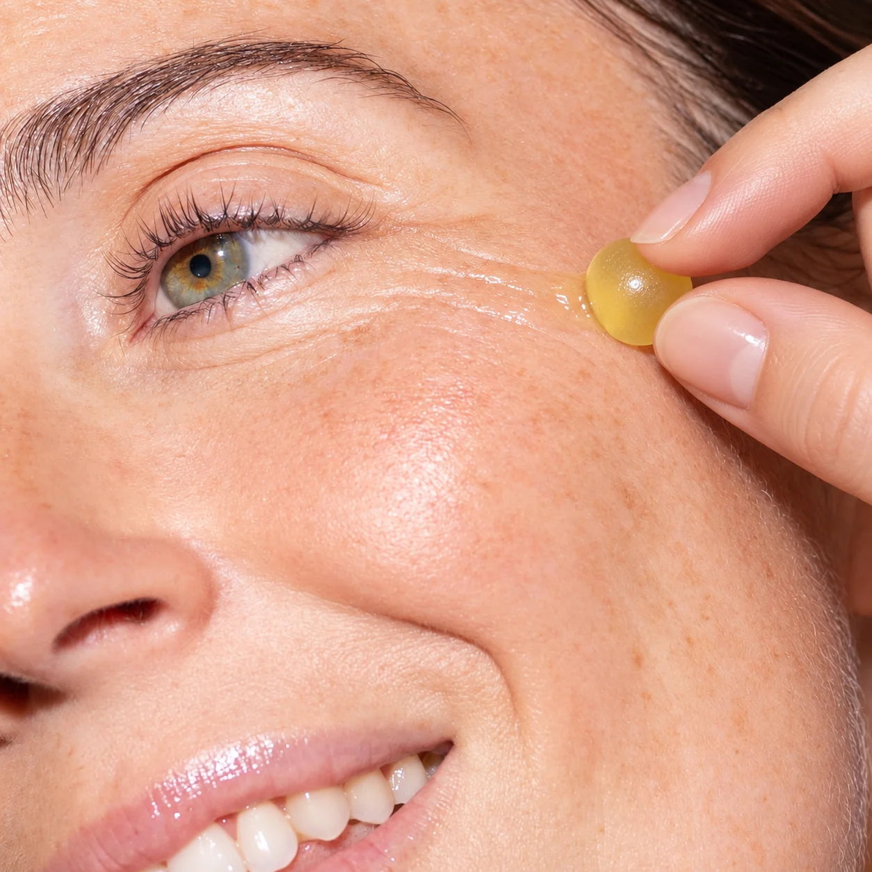 Applying a LIFT Jelly Peptide serum shot sphere directly onto the face. IOKURO